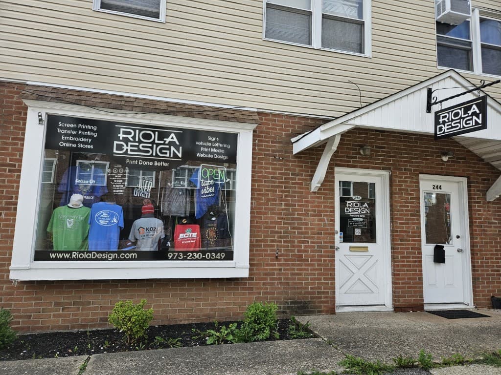 Riola Design storefront at 244 Main Street in Lincoln Park, New Jersey, with custom printed apparel in the window